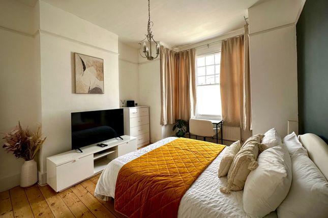 A Bright And Inviting Master Bedroom Featuring A c...