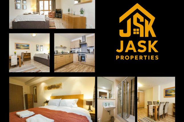 A Bright And Spacious Master Bedroom With A Comfor...