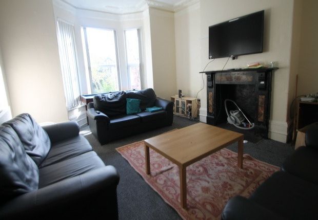 A Spacious, Well-Lit Living Room Featuring Comfort...