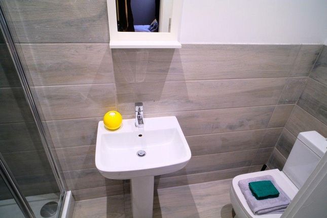 A Modern And Tidy Bathroom Featuring A Clean White...