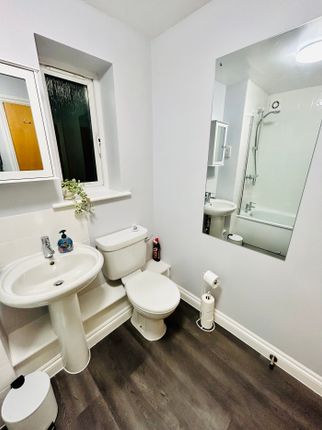A Tidy And Modern Bathroom Featuring A Bath And We...