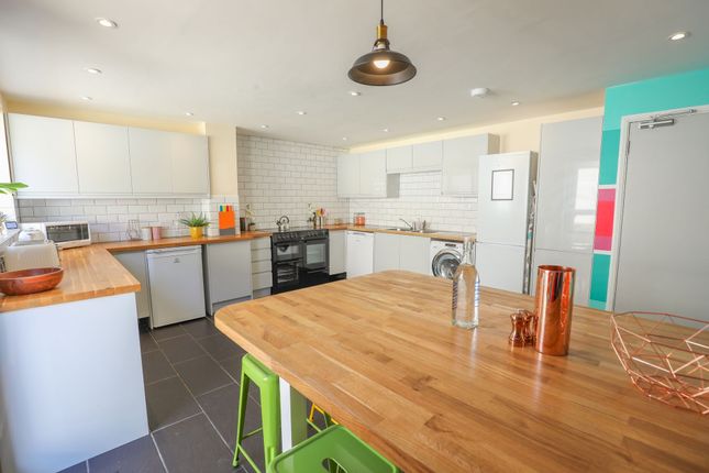 A Modern Kitchen Featuring Sleek Cabinetry And Amp...
