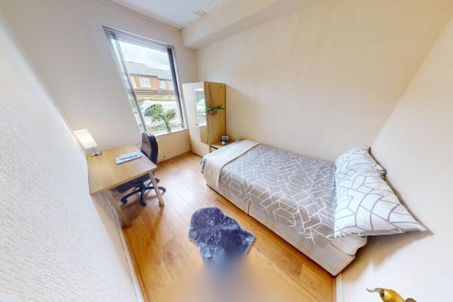 A Bright And Tidy Single Bedroom Featuring A Neatl...