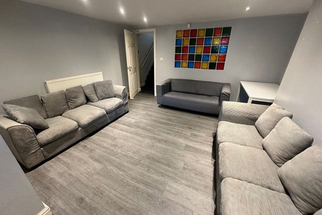 Spacious And Inviting Living Room Featuring Comfor...
