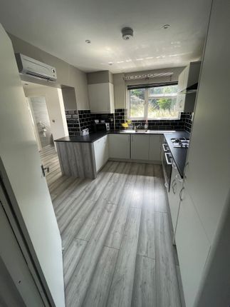 Bright And Modern Kitchen Featuring Sleek White Ca...