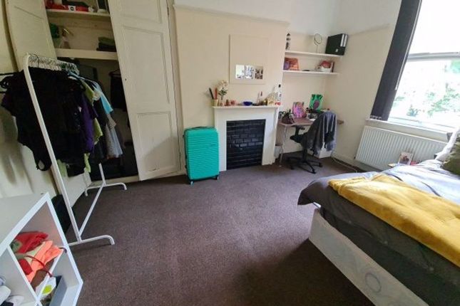 A Spacious And Well-Lit Bedroom Featuring A Large ...