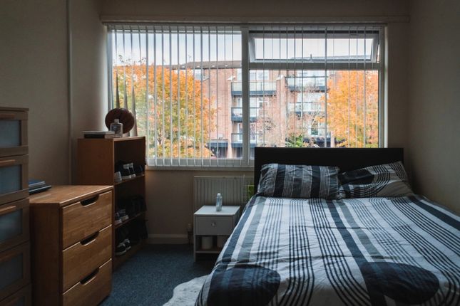 A Cozy Double Bedroom Featuring A Neatly Made Bed ...