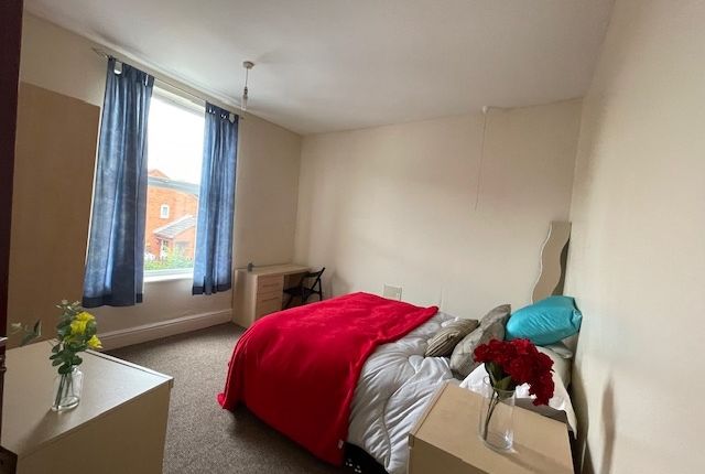 A Cozy Double Bedroom Featuring A Comfortable Bed ...