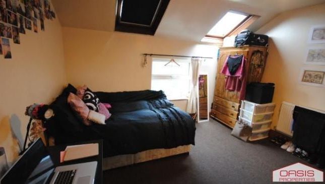 A Cozy And Well-Lit Living Room Featuring A Comfor...