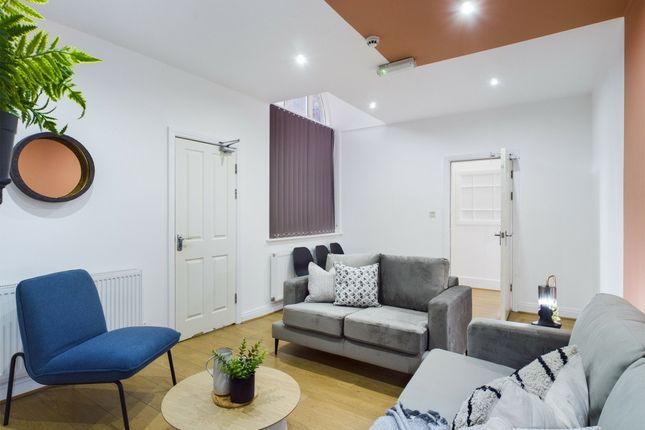 A Welcoming And Spacious Living Room With Modern F...