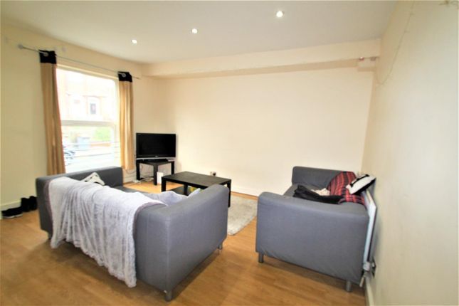 A Cozy Living Room Featuring Two Grey Sofas Arrang...