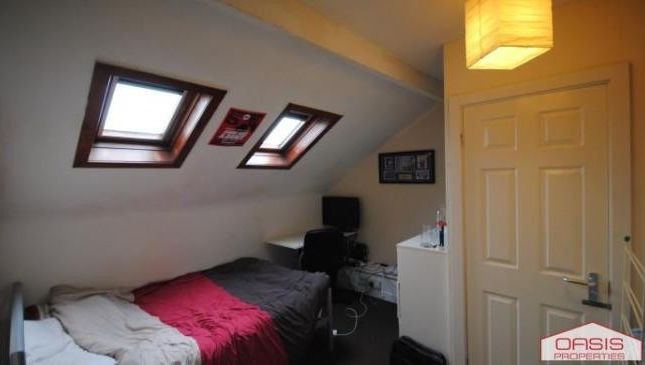 A Cozy Bedroom Featuring A Double Bed, Well-Lit By...