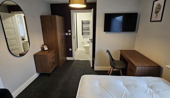 A Modern Double Bedroom Featuring A Comfortable Be...