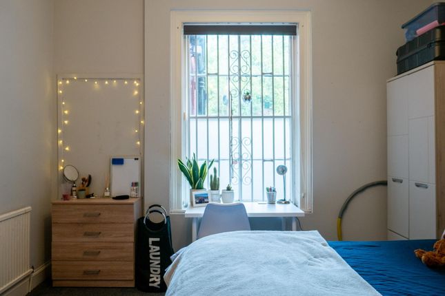 A Bright And Tidy Bedroom Featuring A Large Window...