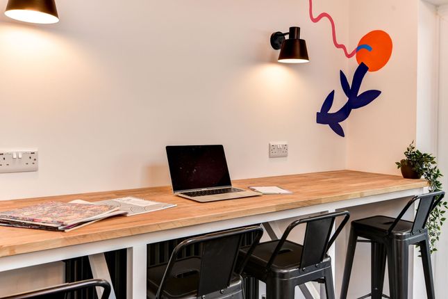 Bright And Inviting Communal Workspace Featuring A...