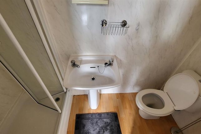 A Compact Bathroom Featuring A White Sink, Toilet,...
