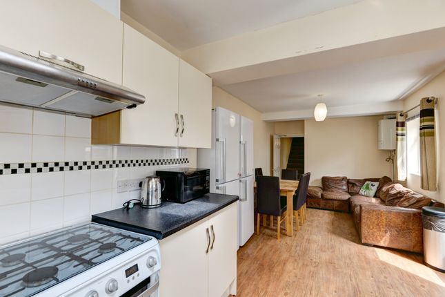 A Cozy And Well-Lit Living Room With A mix Of Comf...