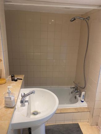 A Functional Bathroom Featuring A Combination Bath...