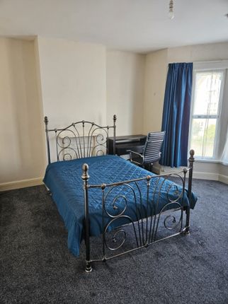 This Charming Double Bedroom Features A Stylish Be...