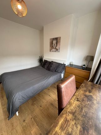 A Cozy Double Bedroom Featuring A Comfortable Bed,...