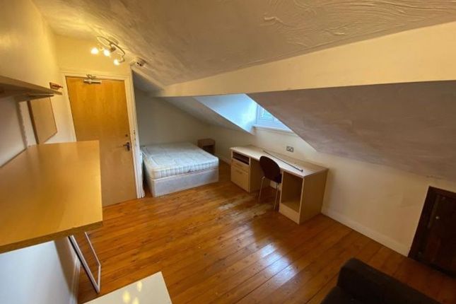 Cozy Bedroom Featuring A Sloped Ceiling, Wooden Fl...