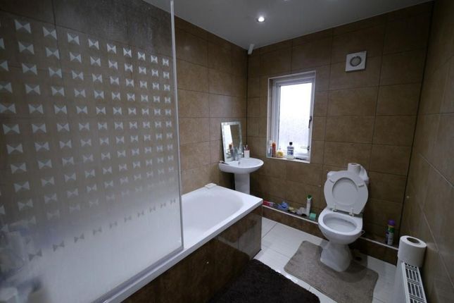 A Modern Bathroom Suite Featuring A Bathtub With G...