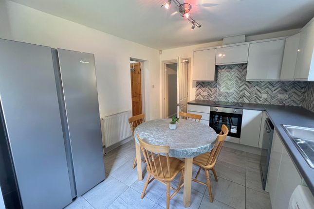 A Bright And Modern Kitchen Featuring A Spacious l...