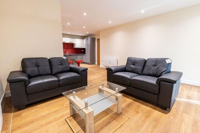 A Modern Living Room Featuring Two Black Leather S...