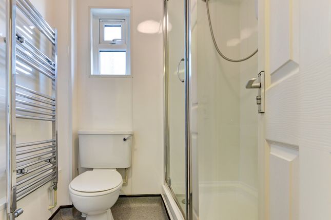 Bright And Clean Bathroom Featuring A Modern Showe...