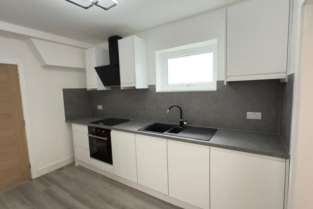 A Modern And Sleek Kitchen Featuring Clean White c...
