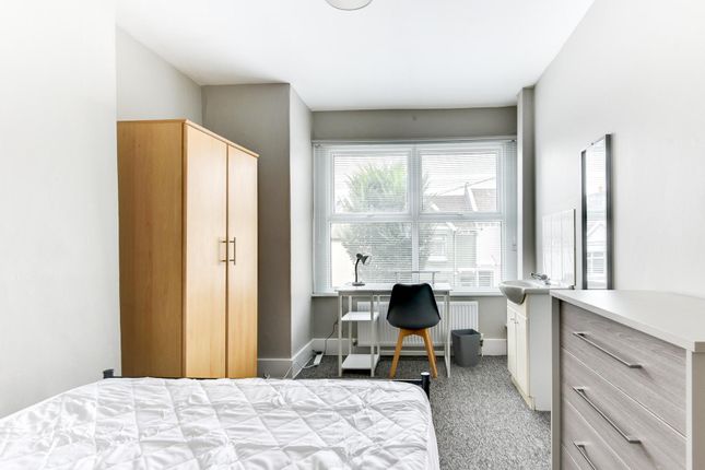 A Bright, Well-Maintained Bedroom Featuring A Larg...