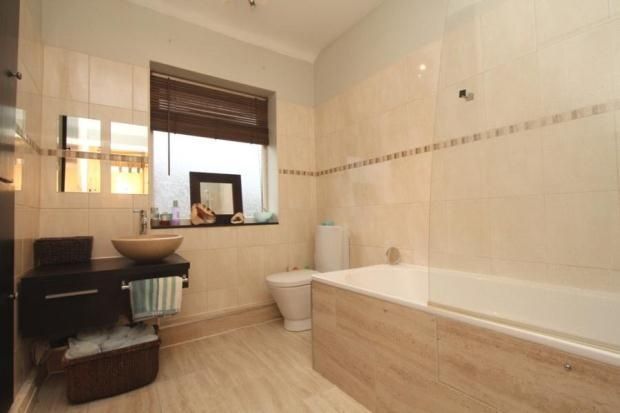 Bright And Modern Bathroom Featuring A Stylish Bas...