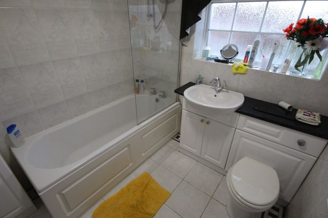 A Well-Maintained Bathroom Featuring A Bathtub And...