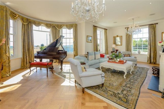 A Spacious And Elegant Living Room Featuring Large...