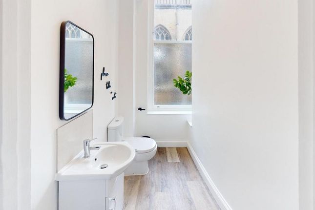 A Bright And Modern Bathroom Featuring Stylish Fix...