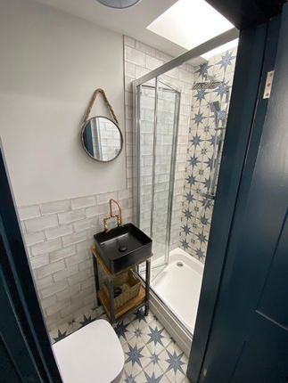 Charming Modern Bathroom With Patterned Shower Til...