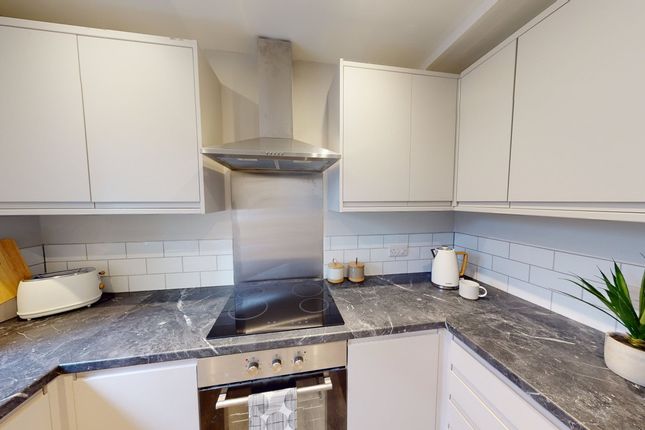A Modern And Tidy Kitchenette With Sleek Cabinetry...