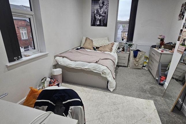 A Cozy Bedroom With A Double Bed Positioned Near T...