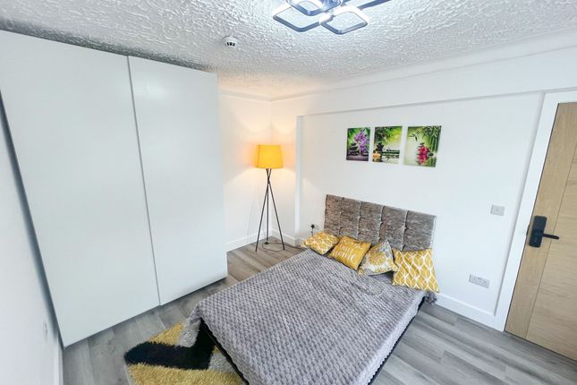 A Modern Double Bedroom Featuring A Comfortable Be...