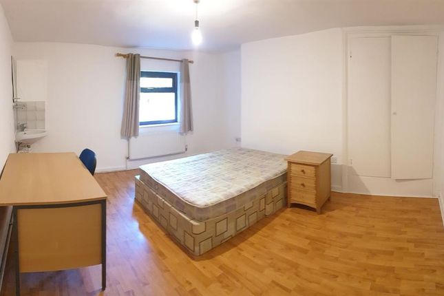 A Bright And Tidy Single Bedroom Featuring A Woode...