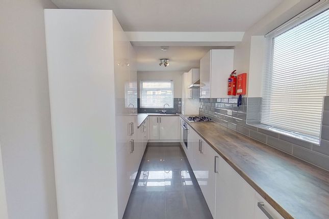 Bright Modern Galley Kitchen With Glossy White Cab...