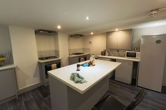 A Modern, Well-Lit Kitchen Featuring A Large Centr...