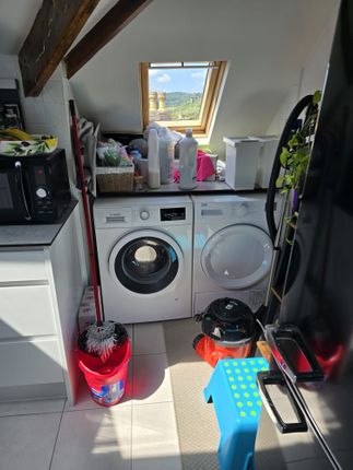 A Bright And Functional Laundry Room With Modern W...