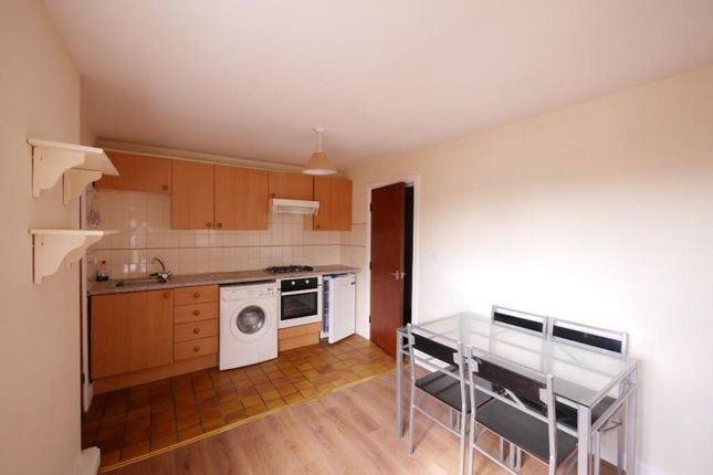 A Bright And Tidy Kitchen Area Featuring Modern Ap...