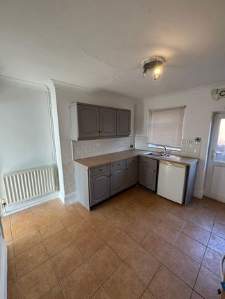 A Compact Kitchen Featuring A Practical L-Shaped c...