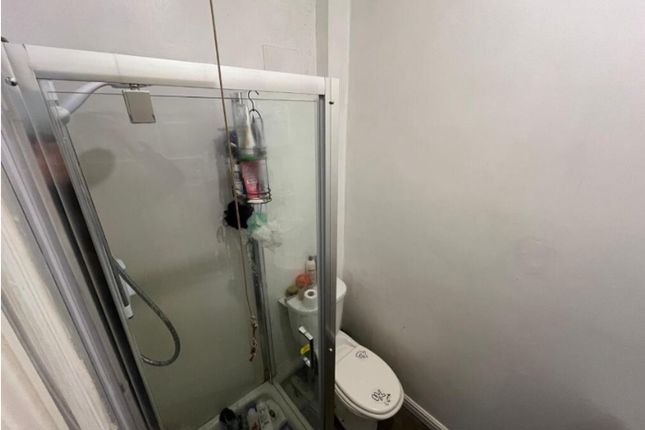 A Functional Single Toilet Area With A Shower, Pro...