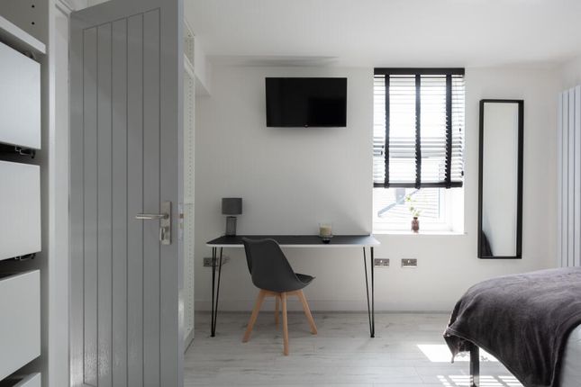 Bright And Modern Master Bedroom Featuring A Styli...