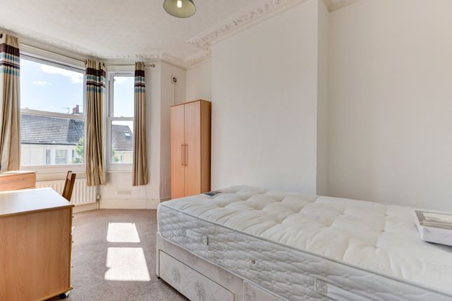 A Bright Single Bedroom Featuring A Large Window T...