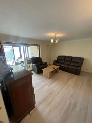 A Spacious And Inviting Living Room Featuring Comf...