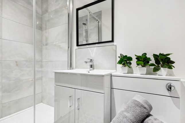 This Modern Bathroom Features Sleek Fixtures And A...